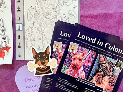 A finished portrait packed flat with the planning sketch, a card and stickers